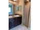 Bathroom featuring a double sink vanity, framed mirrors, and a separate shower area at 4490 Sw 169Th Pl, Ocala, FL 34473