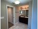 Bathroom with a double sink vanity, granite countertop, decorative lights and tile flooring at 4490 Sw 169Th Pl, Ocala, FL 34473