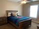 Bedroom with a window view, ceiling fan, and a rustic wood bed frame at 4490 Sw 169Th Pl, Ocala, FL 34473