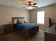 Cozy bedroom with ceiling fan, window, carpet flooring, and neutral wall paint at 4490 Sw 169Th Pl, Ocala, FL 34473