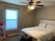 Cozy bedroom with a ceiling fan, a bright window, and a comfortable bed setting at 4490 Sw 169Th Pl, Ocala, FL 34473