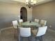 Bright dining area featuring glass table, seating for six, and a stylish chandelier at 4490 Sw 169Th Pl, Ocala, FL 34473