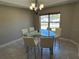 Bright dining area with glass table, seating for six, and tile flooring, perfect for entertaining at 4490 Sw 169Th Pl, Ocala, FL 34473