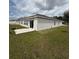 Exterior view of the house and backyard with a patio and well-maintained lawn at 4812 Worchester Dr, Kissimmee, FL 34746