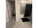 Bathroom showcasing a shower-tub combo with a black shower curtain and tiled wall at 4812 Worchester Dr, Kissimmee, FL 34746