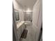 This bathroom has tile floors, bath and shower combo, and white cabinets at 4812 Worchester Dr, Kissimmee, FL 34746