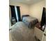 Carpeted bedroom features a comfortable bed, dresser, and dark-colored window coverings at 4812 Worchester Dr, Kissimmee, FL 34746