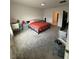 Carpeted bedroom featuring a comfortable bed, desk, and closet at 4812 Worchester Dr, Kissimmee, FL 34746