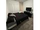 Comfortable bedroom with carpet flooring, closet space, and a black dresser with tv at 4812 Worchester Dr, Kissimmee, FL 34746