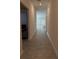Bright hallway featuring neutral tile flooring leading to a naturally lit living space at 4812 Worchester Dr, Kissimmee, FL 34746