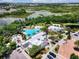 Aerial shot displays a resort-style pool and amenity center with mature landscaping and ample parking spaces at 510 Captiva Dr, Davenport, FL 33896