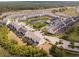 Aerial view of townhome community showcasing central pond, lush landscaping, and easy highway access at 510 Captiva Dr, Davenport, FL 33896