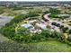An aerial view highlights the pool, clubhouse, and green surroundings near a residential area at 510 Captiva Dr, Davenport, FL 33896