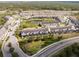 Aerial view of townhome community showcasing central pond, lush landscaping, and easy highway access at 510 Captiva Dr, Davenport, FL 33896