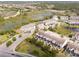 Aerial view of community showcasing pond, lush landscaping, and easy highway access at 510 Captiva Dr, Davenport, FL 33896
