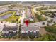 Aerial view of townhome in a community featuring ponds, mature trees and ample parking at 510 Captiva Dr, Davenport, FL 33896