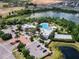 Aerial perspective of a clubhouse, pool, and amenity center with manicured landscaping and parking at 510 Captiva Dr, Davenport, FL 33896