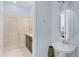 Powder room with pedestal sink and doorway view of a luxurious full bath at 510 Captiva Dr, Davenport, FL 33896