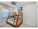 Bright bedroom with stylish bunk bed, ceiling fan, and beach-themed decorations at 510 Captiva Dr, Davenport, FL 33896