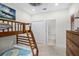 Bedroom featuring bunk beds, a ladder, and a doorway to a bathroom with tiled floor at 510 Captiva Dr, Davenport, FL 33896