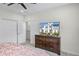 Bright bedroom featuring a spacious closet and a sleek dresser with a large flat screen TV at 510 Captiva Dr, Davenport, FL 33896