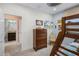 Bedroom featuring bunk beds, a ceiling fan, and access to a bathroom with granite countertops at 510 Captiva Dr, Davenport, FL 33896