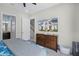 Bright bedroom featuring a dark wood dresser and TV with neighborhood view at 510 Captiva Dr, Davenport, FL 33896