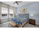 Bedroom with beachy décor, large window with natural light, and a bench at 510 Captiva Dr, Davenport, FL 33896