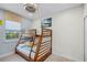 A delightful bedroom featuring a wooden bunk bed, carpet, and window views at 510 Captiva Dr, Davenport, FL 33896