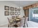 Cozy dining area with glass table and chairs, stylish décor, and access to the outdoor patio area at 510 Captiva Dr, Davenport, FL 33896
