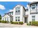 Charming townhome with white stucco, gray trim accents, and lovely landscaping, creating curb appeal at 510 Captiva Dr, Davenport, FL 33896
