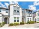 Beautiful two-story townhome with grey and white trim and lush landscaping at 510 Captiva Dr, Davenport, FL 33896