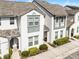 Beautiful two-story townhome featuring neutral paint, manicured landscaping and a cozy front porch at 510 Captiva Dr, Davenport, FL 33896