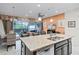 Open kitchen boasts granite countertops and island with backyard view of dining, living area, and pool at 510 Captiva Dr, Davenport, FL 33896