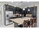 Stylish kitchen featuring dark cabinetry, granite countertops, stainless steel appliances, and a large island at 510 Captiva Dr, Davenport, FL 33896