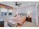 Tranquil bedroom with tropical décor, a ceiling fan, and ample natural light from the large windows at 510 Captiva Dr, Davenport, FL 33896