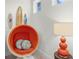 A cozy reading nook with surf board decor, and a comfortable orange pod chair at 510 Captiva Dr, Davenport, FL 33896