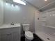 Updated bathroom with white vanity, modern fixtures, and a shower featuring clear glass sliding doors at 5161 Howison Rd, Kissimmee, FL 34746