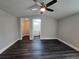 Spacious bedroom with modern ceiling fan, wood flooring and walk-in closet and ensuite bathroom at 5161 Howison Rd, Kissimmee, FL 34746