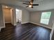 Spacious bedroom with modern ceiling fan, wood flooring and walk-in closet and ensuite bathroom at 5161 Howison Rd, Kissimmee, FL 34746