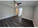 Spacious bedroom with modern ceiling fan, wood flooring and walk-in closet and ensuite bathroom at 5161 Howison Rd, Kissimmee, FL 34746