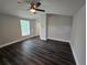 Large, naturally lit bedroom features updated flooring, neutral paint, and convenient ensuite access at 5161 Howison Rd, Kissimmee, FL 34746