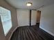 Naturally lit bedroom featuring updated flooring, neutral paint, and a standard closet at 5161 Howison Rd, Kissimmee, FL 34746