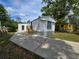 Charming exterior of a one-story home with a large driveway and front yard at 5161 Howison Rd, Kissimmee, FL 34746