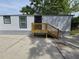 Exterior side view of the house with new wooden steps to the front door at 5161 Howison Rd, Kissimmee, FL 34746