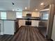 Modern kitchen featuring stainless steel appliances, dark countertops and stylish lighting at 5161 Howison Rd, Kissimmee, FL 34746