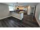 Bright kitchen features stainless appliances, sleek countertops, modern fixtures, and dark wood flooring at 5161 Howison Rd, Kissimmee, FL 34746