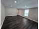 Inviting living room with new floors and plenty of natural light, perfect for relaxing at 5161 Howison Rd, Kissimmee, FL 34746