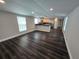 Bright living room with new flooring that flows into the modern kitchen area at 5161 Howison Rd, Kissimmee, FL 34746