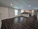 Living room featuring new floors, fresh paint, and a view into the kitchen at 5161 Howison Rd, Kissimmee, FL 34746